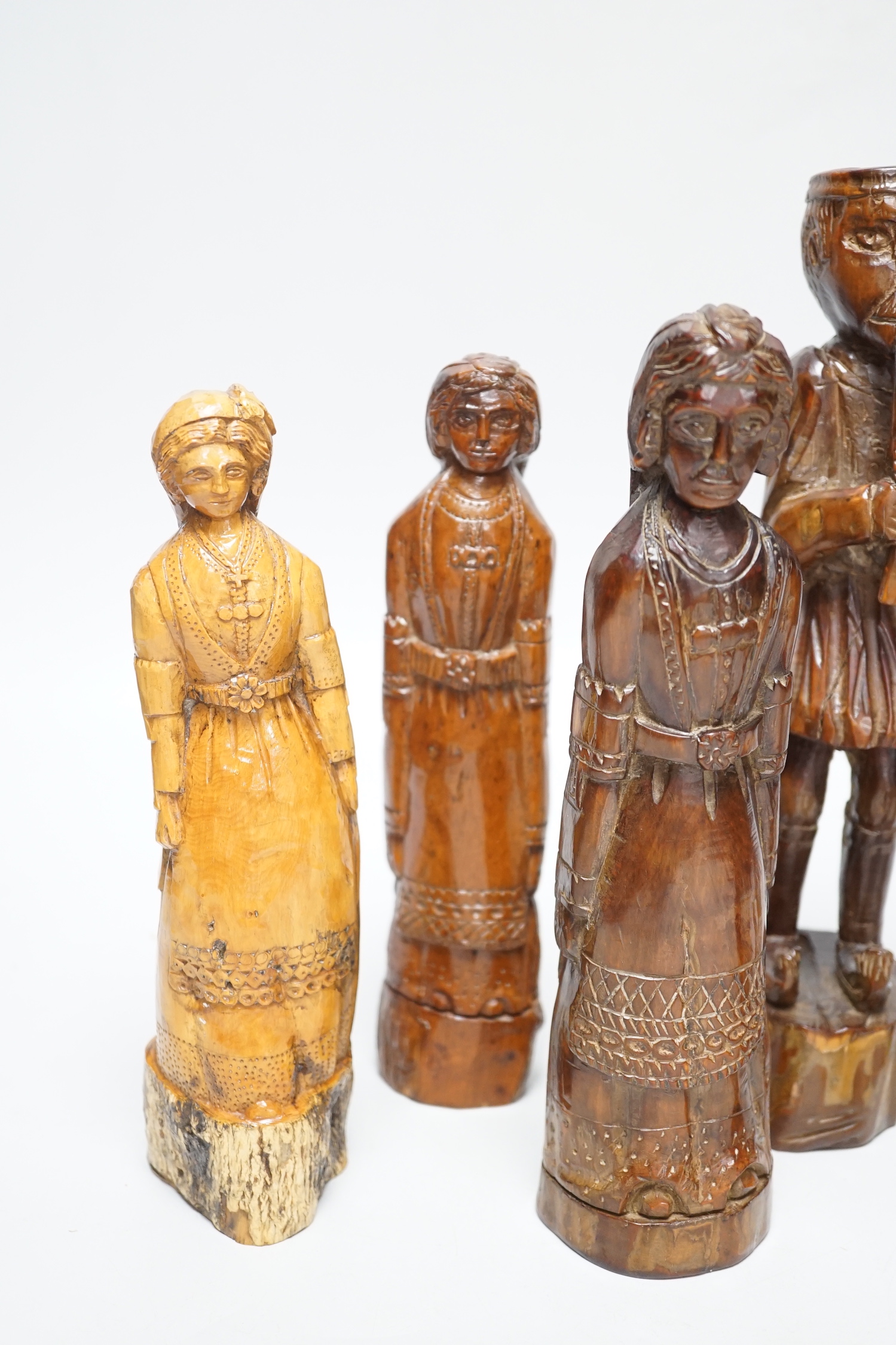 A collection of Greek carved olivewood and treen carved figures, 19th century, largest 25cm